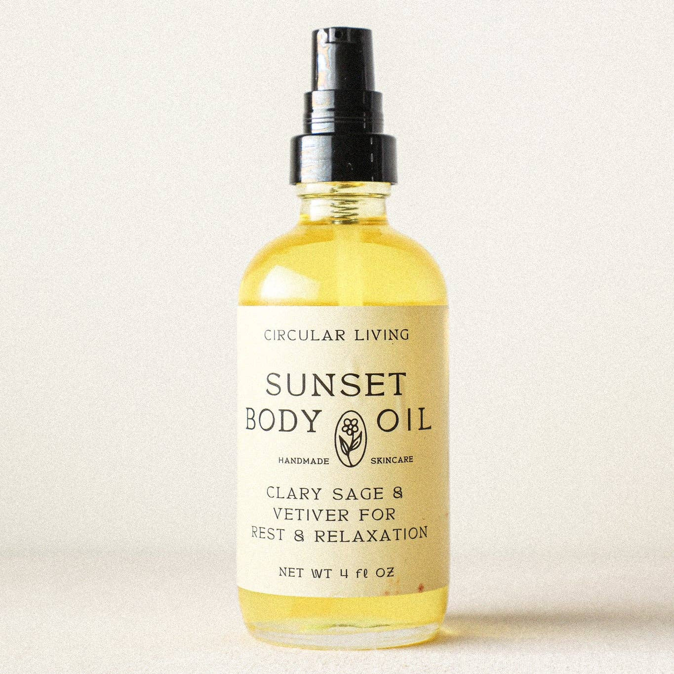 Bottle of Sunset Body Oil with a label on a white background