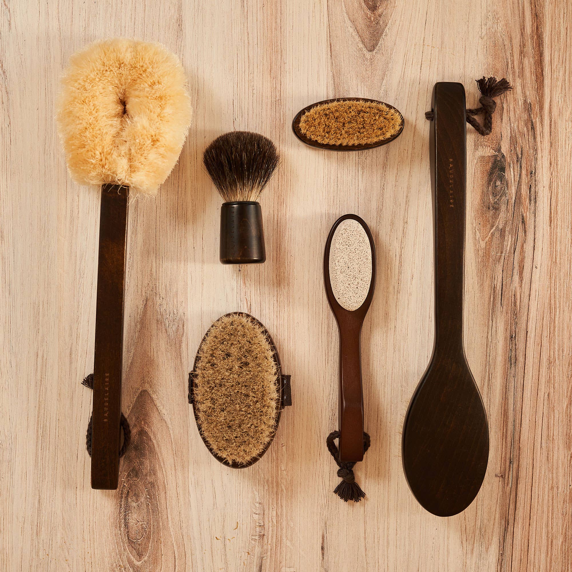 Set of grooming brushes and tools on a wooden surface