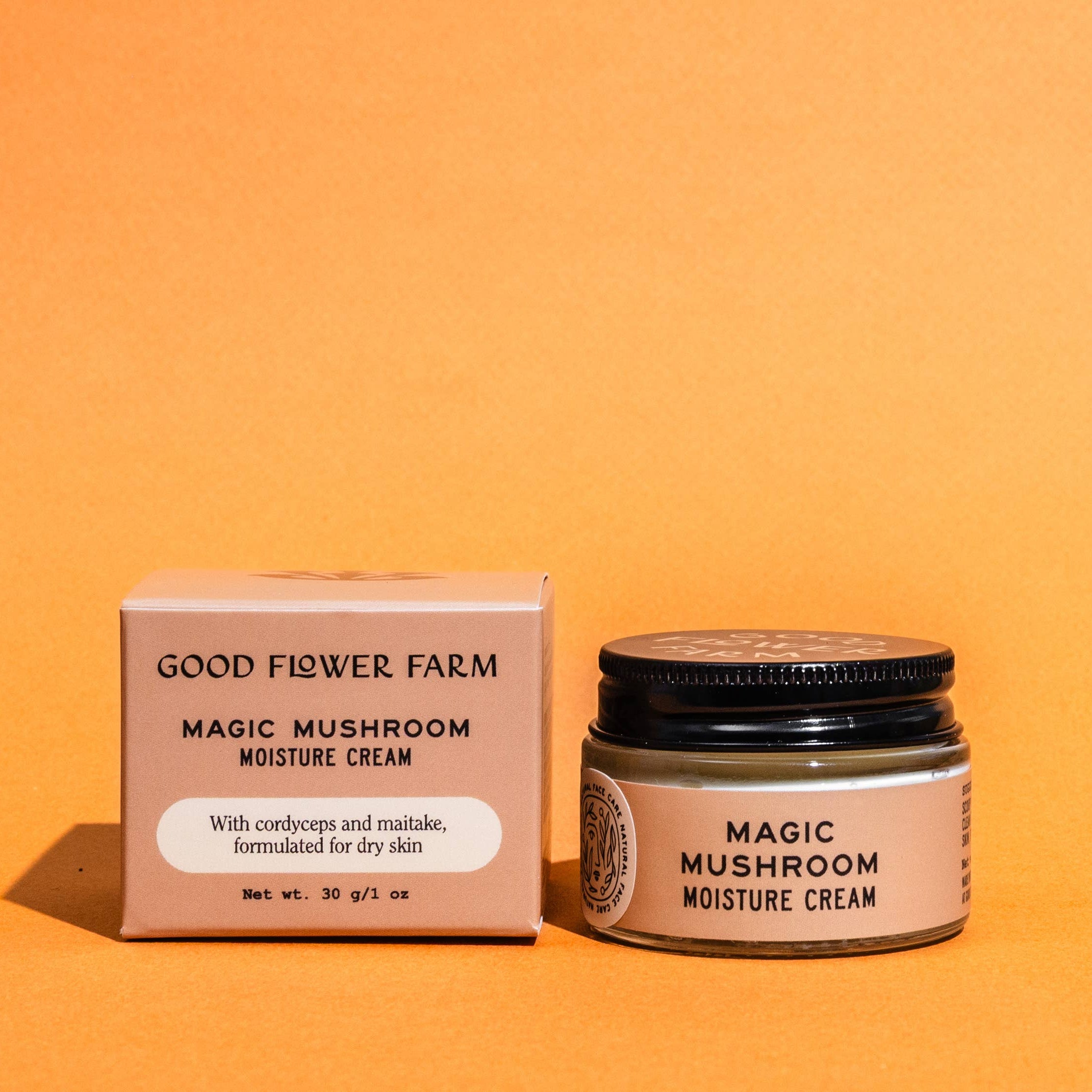 Good Flower Farm Magic Mushroom Moisture Cream jar and box on an orange background