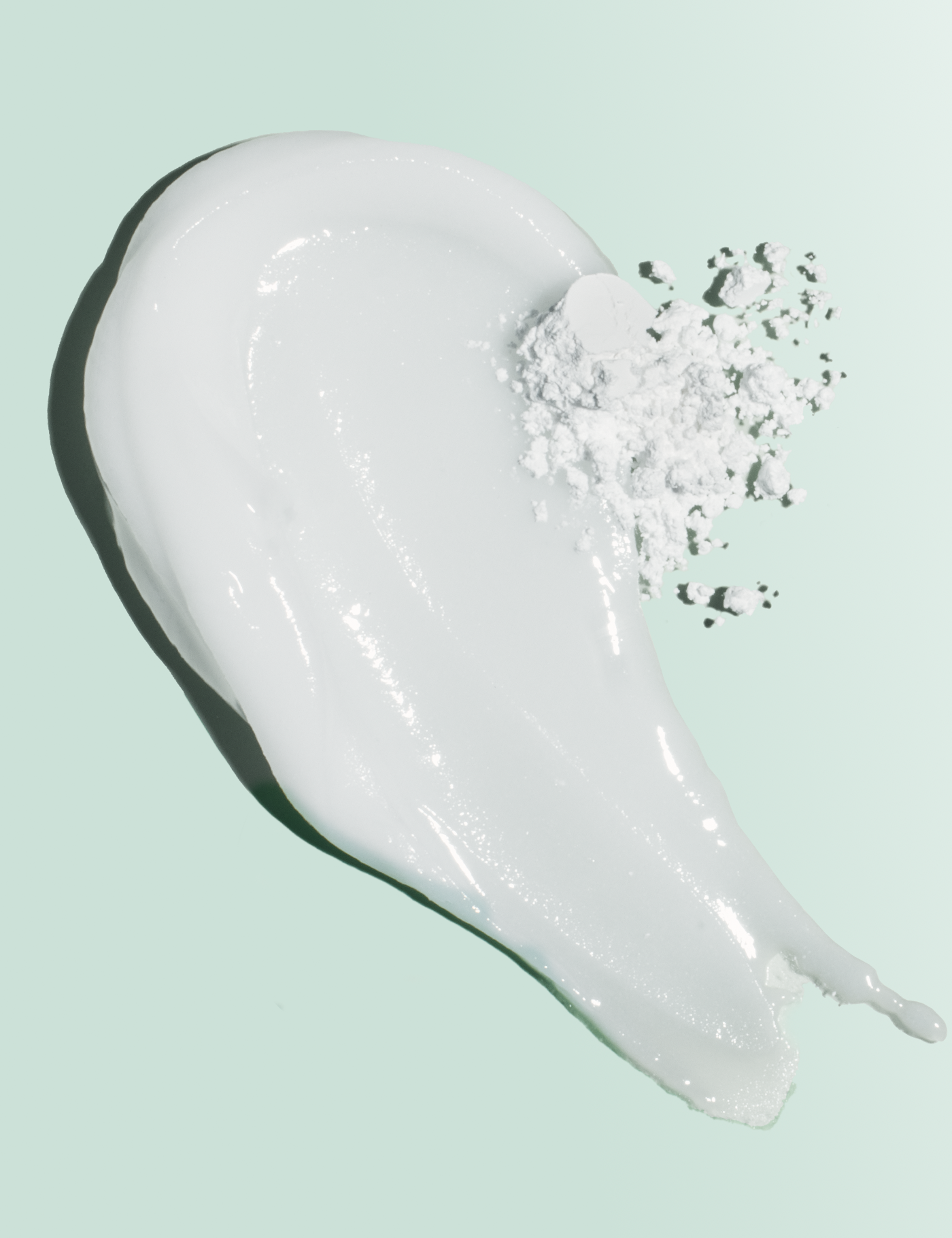 White cream with black specks on a light green background