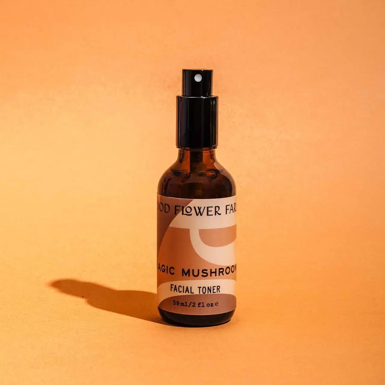 Bottle of facial toner with a label on an orange background