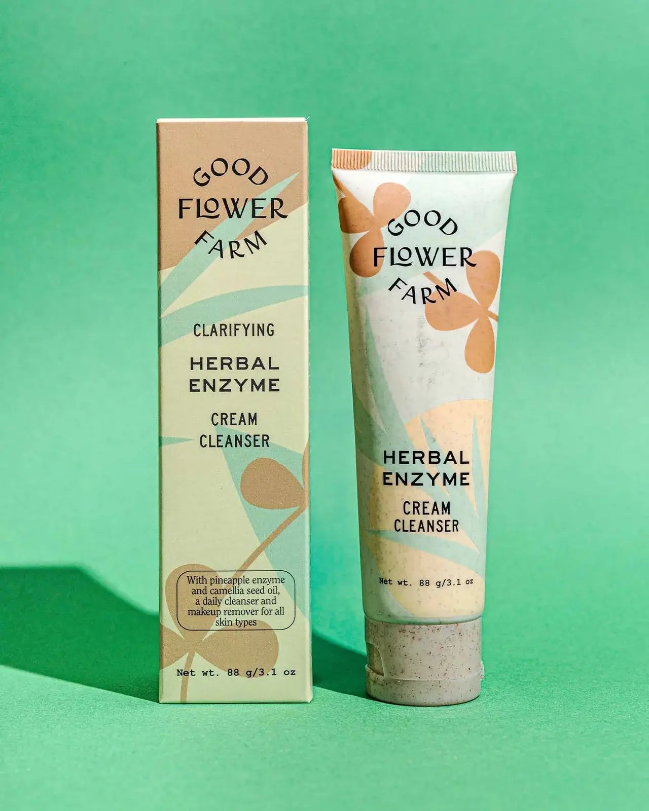 Good Flower Farm herbal enzyme cream cleanser with packaging on a green background