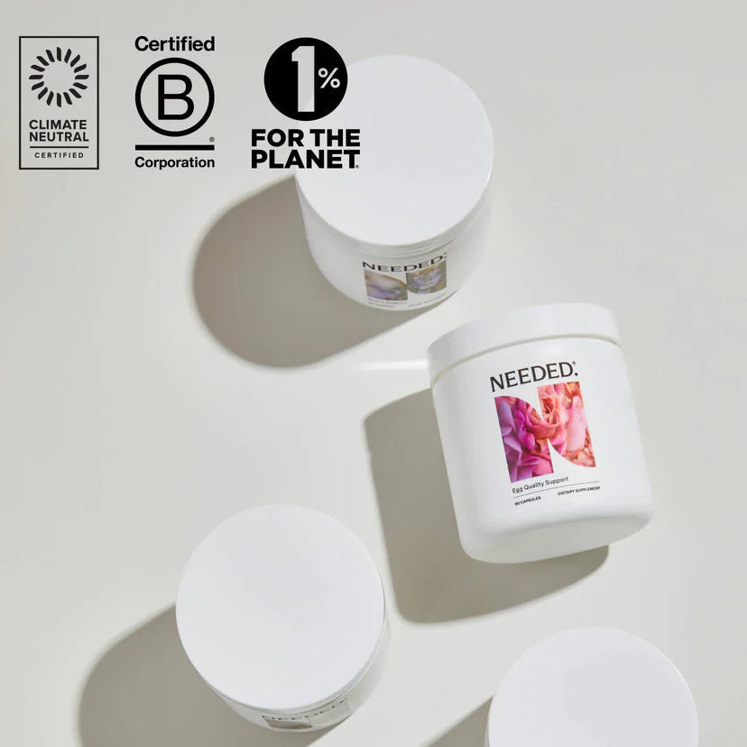 Candle jars with 'NEEDLED' branding on a light background, featuring sustainability certification logos.