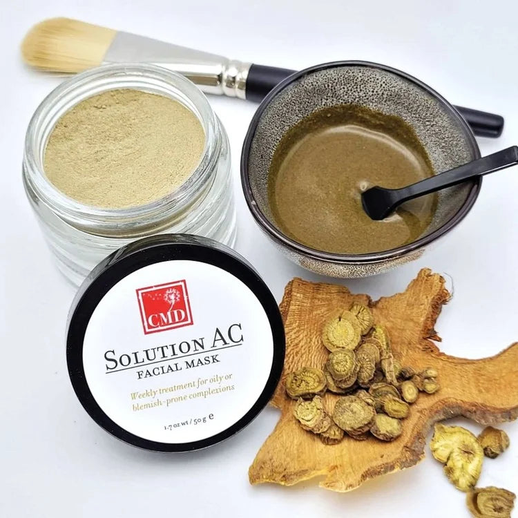Facial mask jar with powder, a bowl of solution, and CMD Solution AC packaging on a white background.