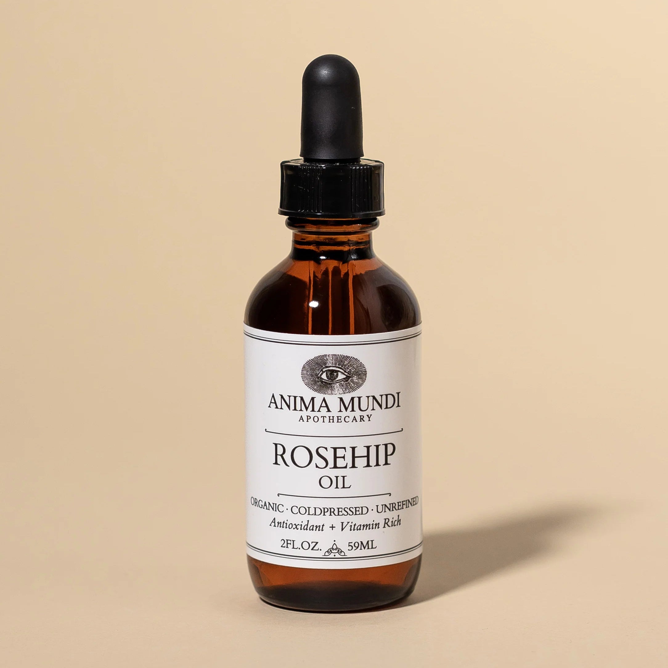 Bottle of Anima Mundi Apothecary Rosehip Oil on a beige background