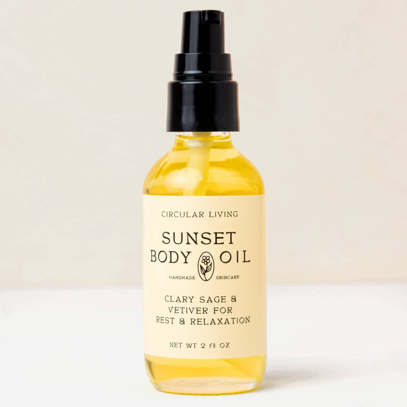 Bottle of Sunset Body Oil with a beige background