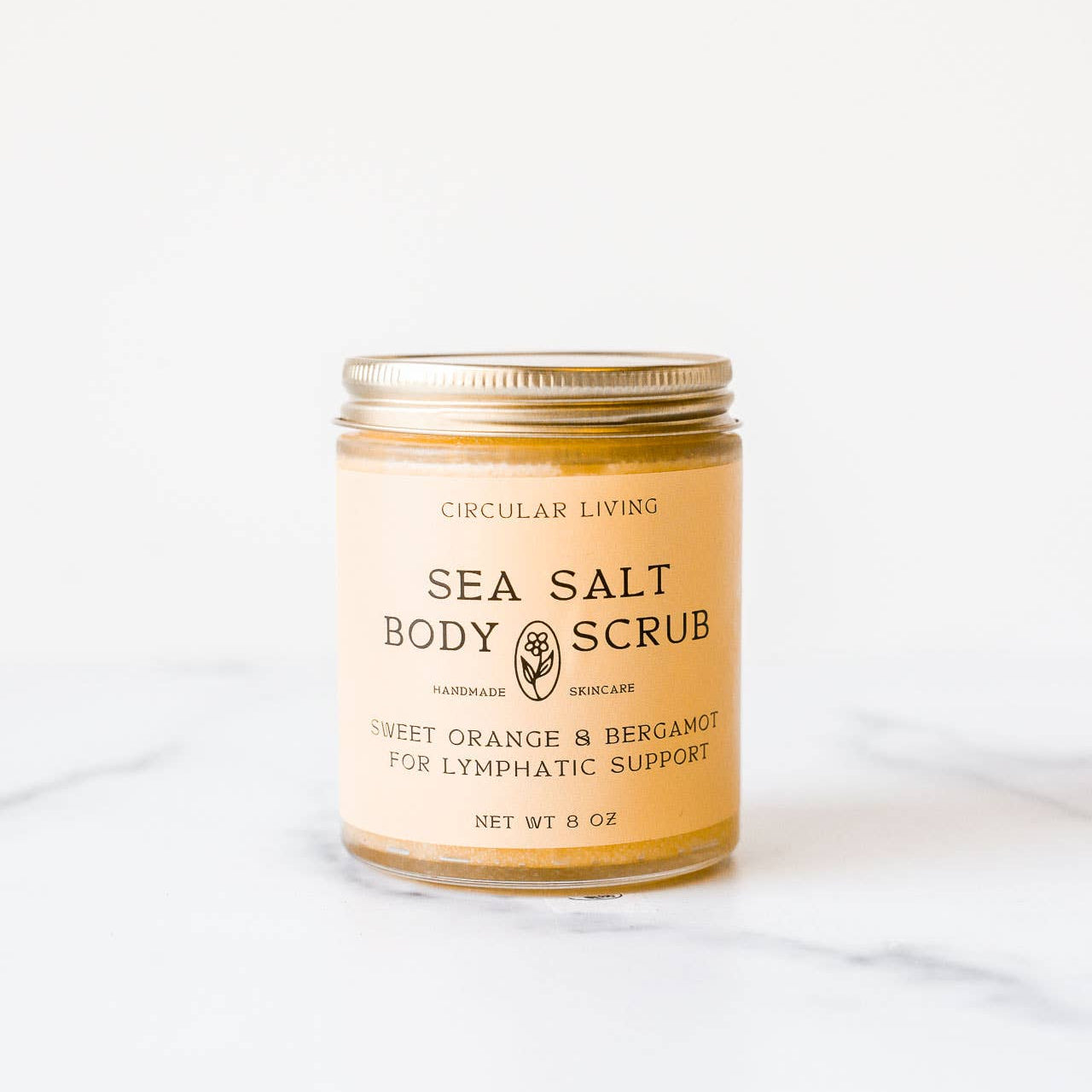 Jar of sea salt body scrub on a white background