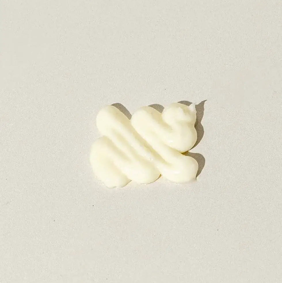 Cream-colored swirl on a light gray background