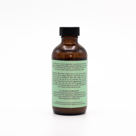 Brown glass bottle with a green label on a white background