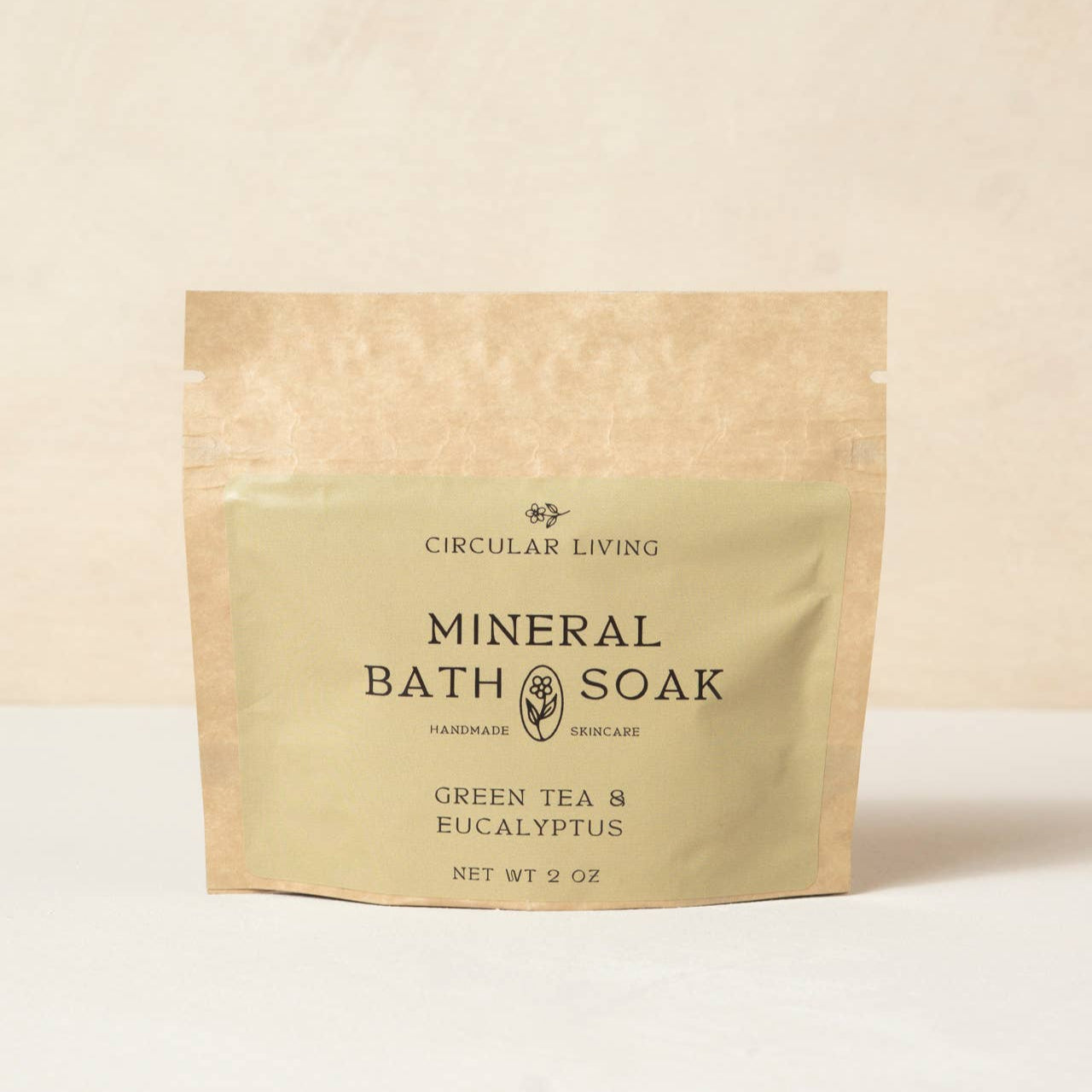 Kraft paper packaging of Circular Living Mineral Bath Soak with green tea and eucalyptus on a beige background