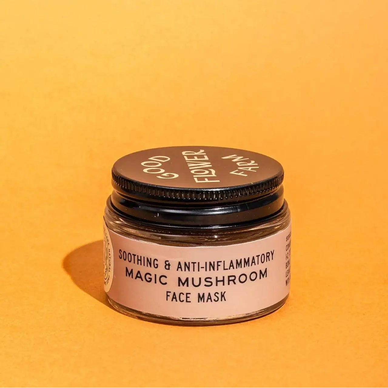 Jar of soothing and anti-inflammatory magic mushroom face mask on an orange background