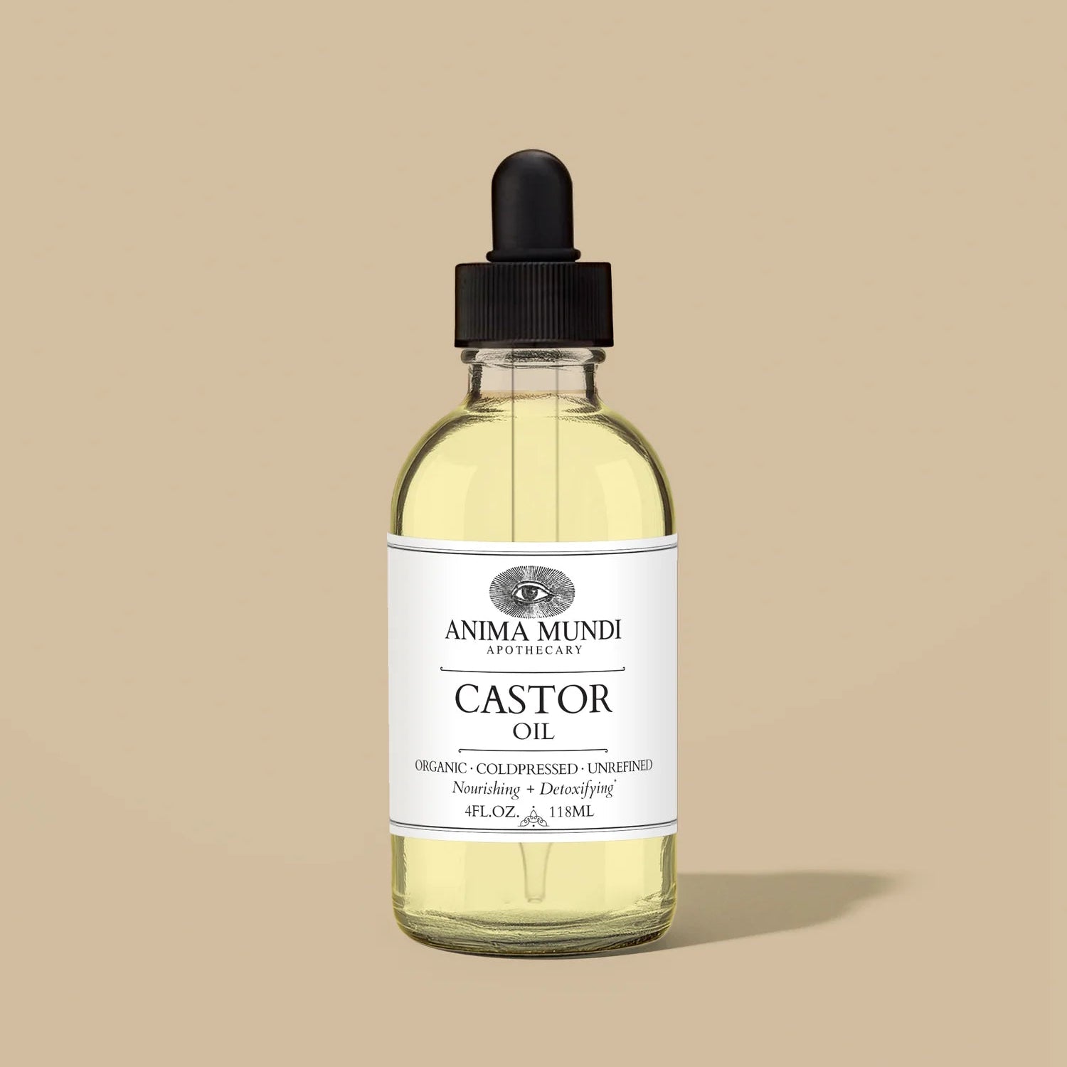 Bottle of Anima Mundi Castor Oil with dropper on a beige background