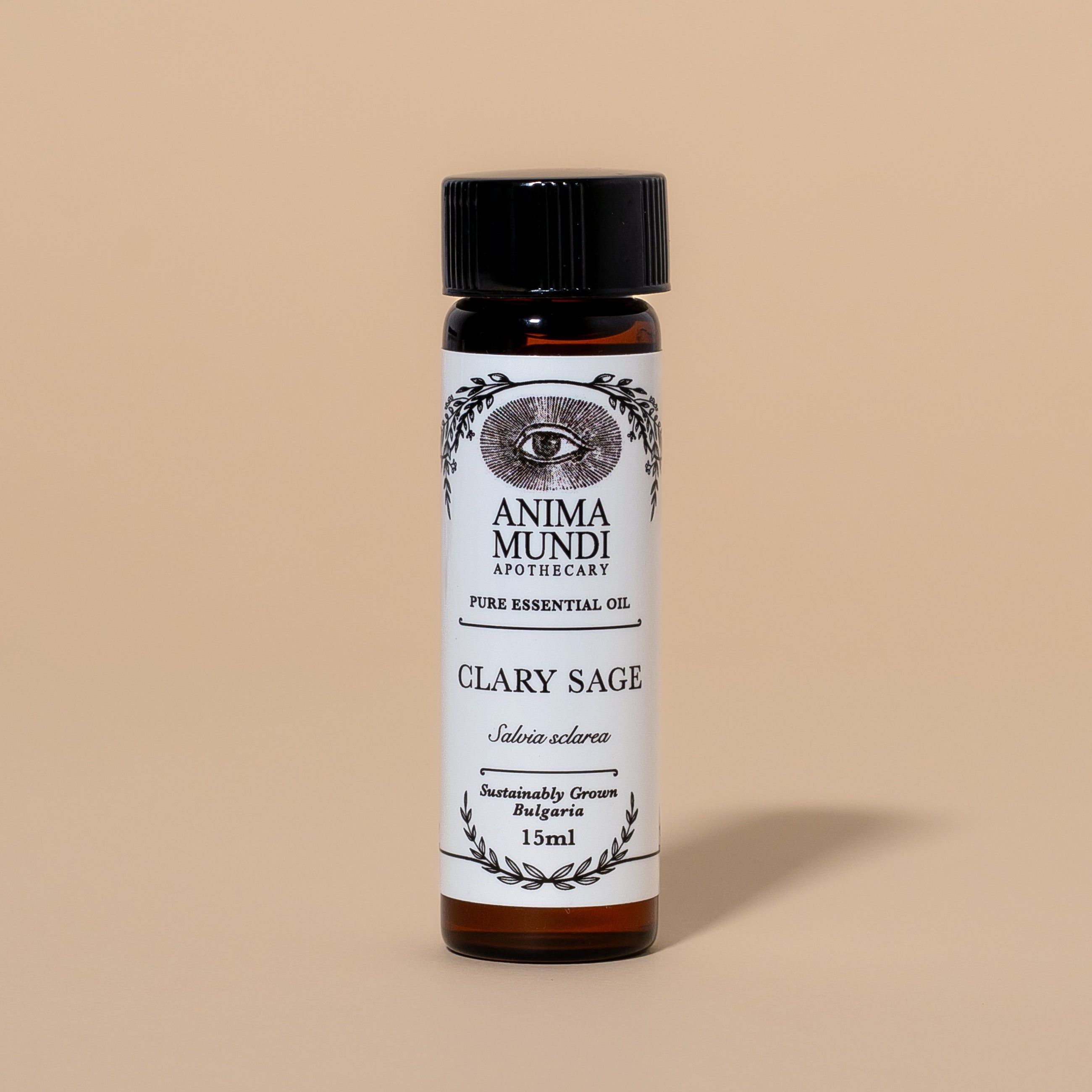 Bottle of Anima Mundi Clary Sage essential oil on a beige background