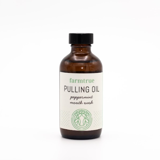 Brown bottle of Farmtrue Pulling Oil on a white background