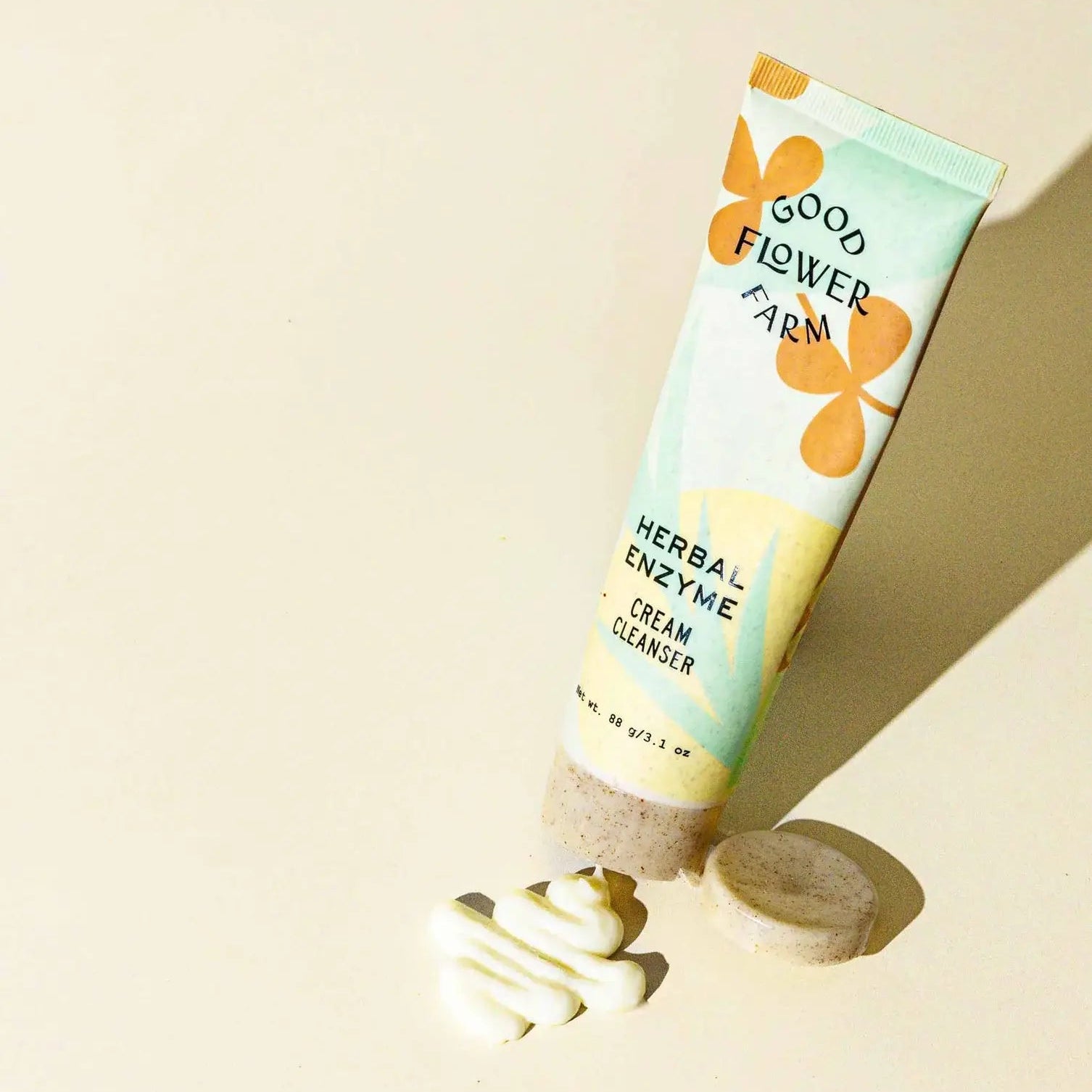 Tube of Good Flower Farm cream cleanser on a beige background